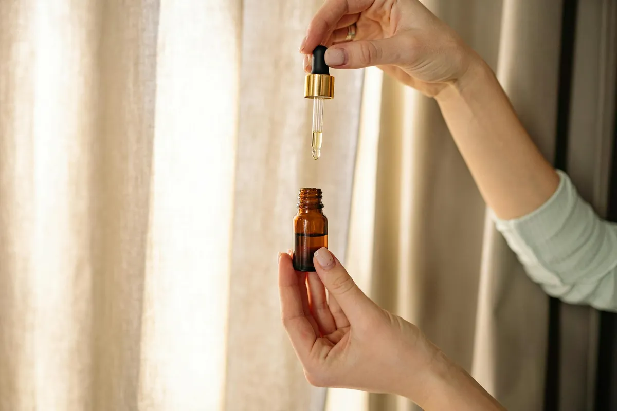 A hemp oil dropper resting on a clean kitchen counter in morning light