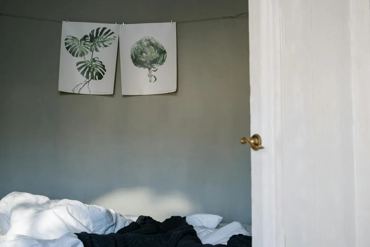 A linen-covered bed in a quiet room at first light